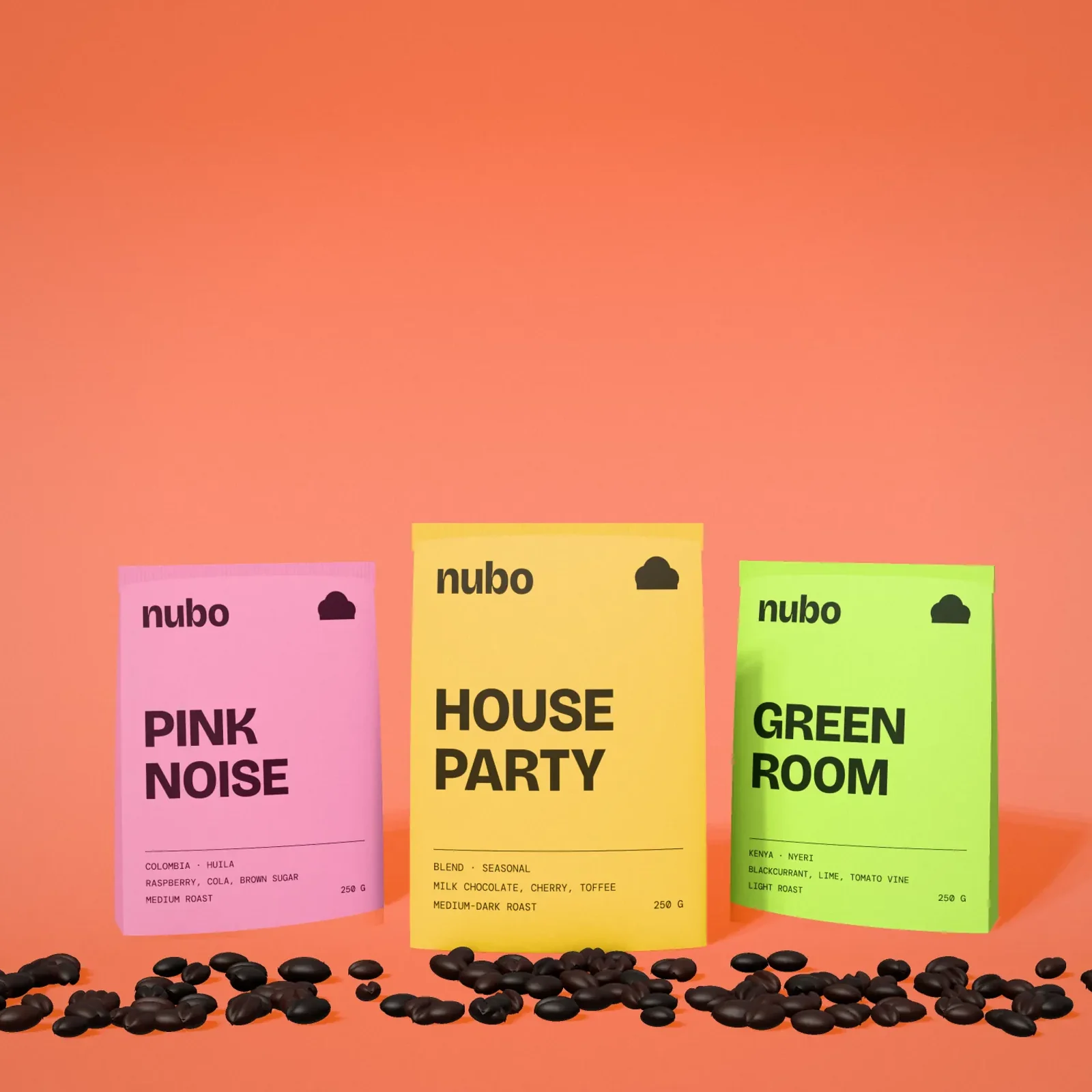 Three Nubo coffee pouches, pink, yellow, and green, with roasted beans on an orange floor