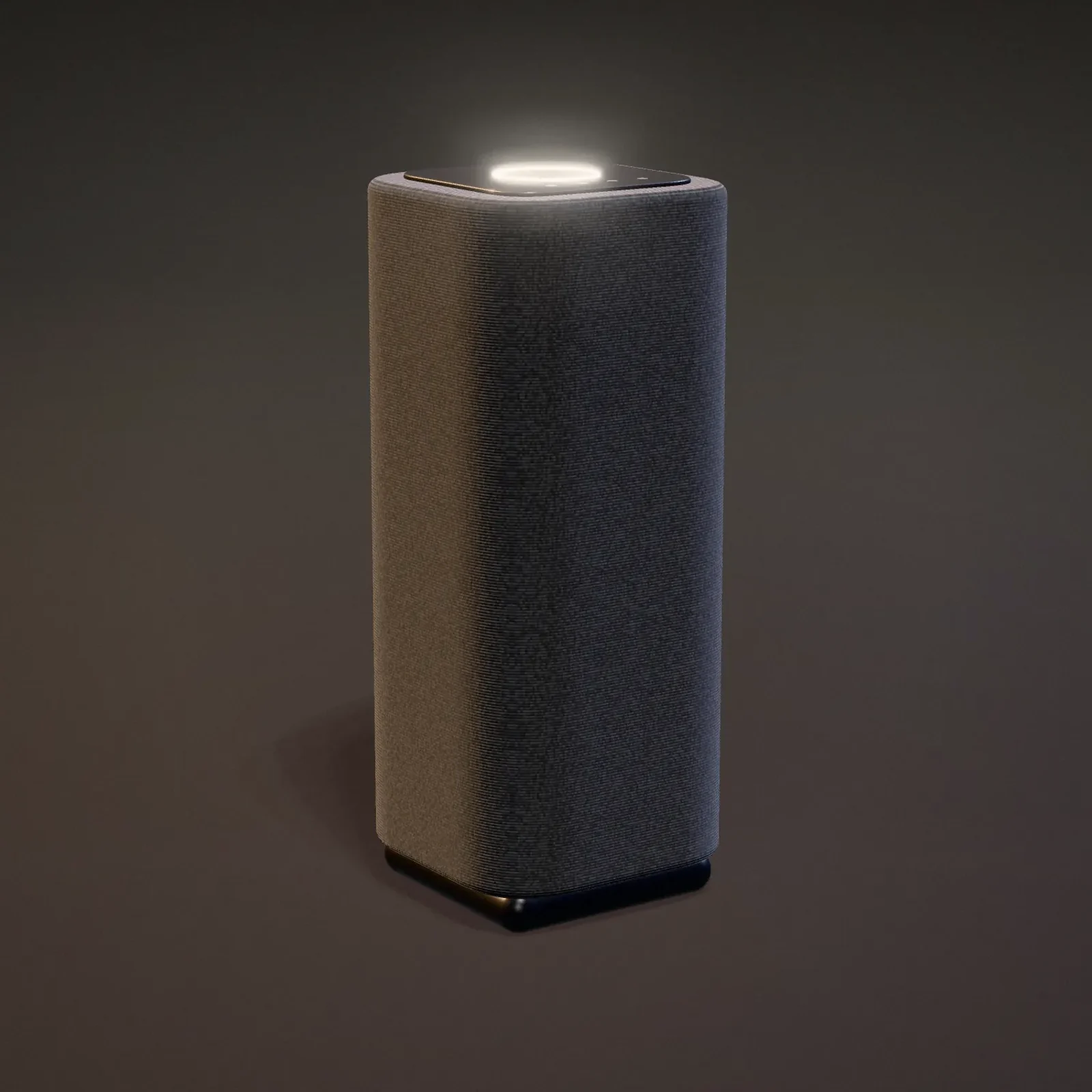 The Plinth Model 01 speaker in graphite knit, rim-lit on a dark stage with its light ring glowing